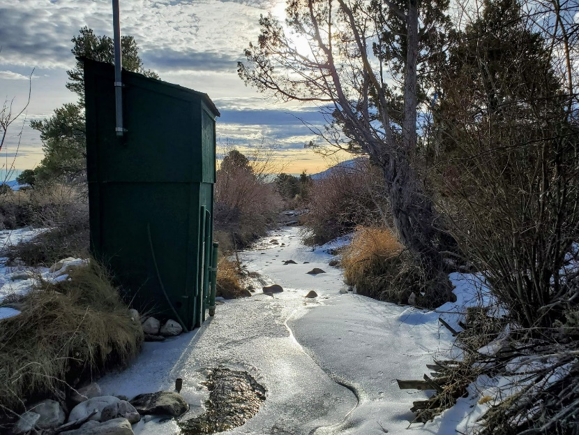 Phhotograph of a stream covered in ice, an example of a stream gage that would be ice-affected.